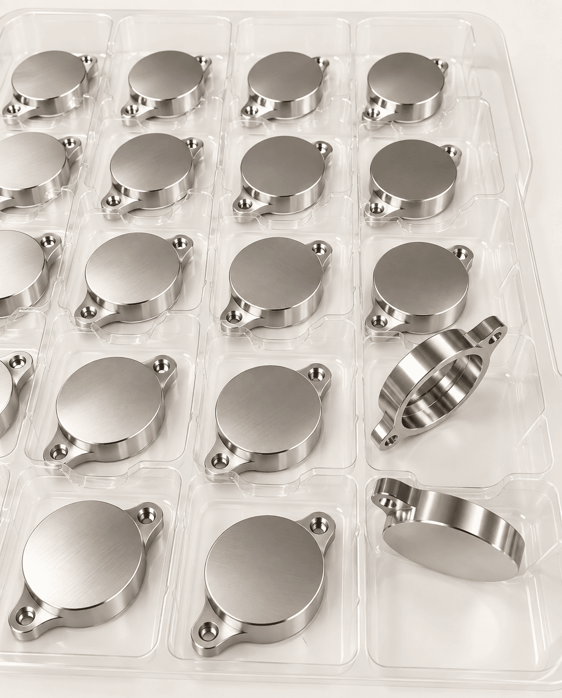 Machined metal components arranged in protective trays